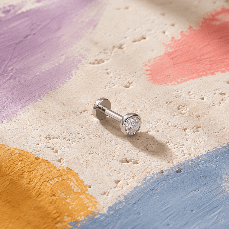 Flat back labret stud with a bezel-set cubic zirconia